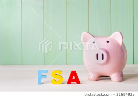 FSA theme with wood block letters and a piggy bank FSA theme with wood block letters and a piggy bank 31694922