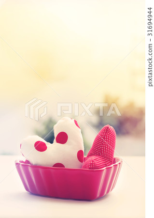 Heart cushions in a red heart dish Heart cushions in a red heart dish 31694944