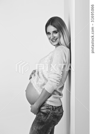 Beautiful pregnant woman in jeans Beautiful pregnant woman in jeans 31695866