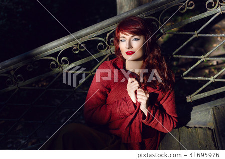 Girl sitting on old house stairs 31695976