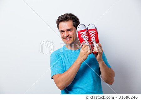 Portrait of young man with red gumshoes 31696240