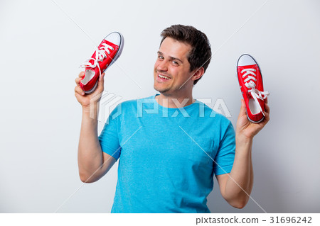 Portrait of young man with red gumshoes Portrait of young man with red gumshoes 31696242