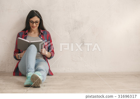 Young woman with a book studio portrait Young woman with a book studio portrait 31696317