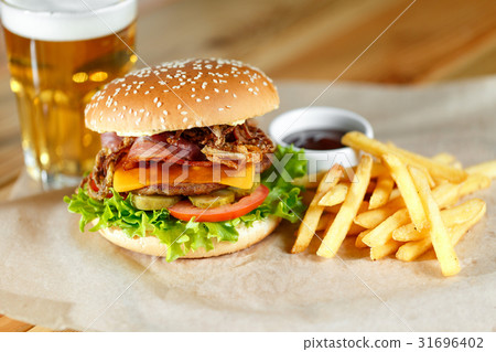 Big tasty burger and fries with beer on backround 31696402