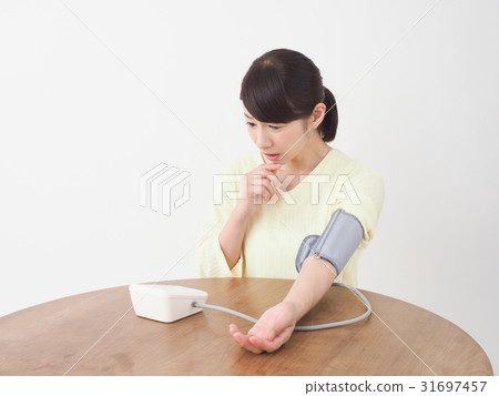 A woman surprised measuring blood pressure A woman surprised measuring blood pressure 31697457