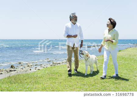 Senior couple and dog grassland and blue sky Senior couple and dog grassland and blue sky 31698778