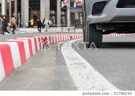 illegally parked car on red curb 31706243