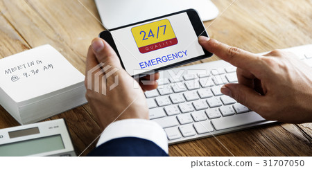 Hand holding digital device with 24/7 service 31707050