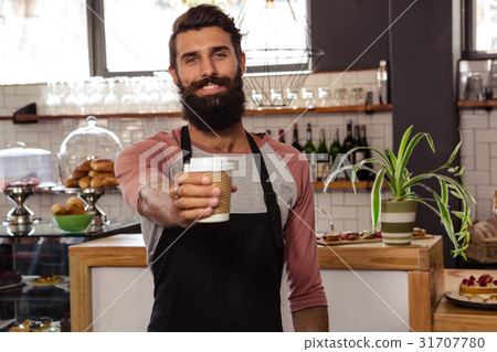 Waiter presenting a disposable cup 31707780
