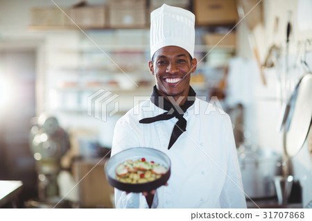 Portrait of head chef presenting salad Portrait of head chef presenting salad 31707868