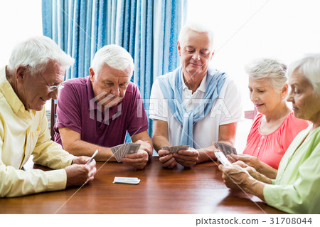 Seniors playing cards together 31708044