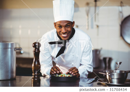 Portrait of smiling chef preparing a salad Portrait of smiling chef preparing a salad 31708434
