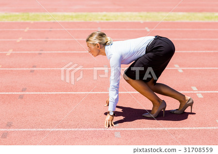 Businesswoman ready to run on running track 31708559
