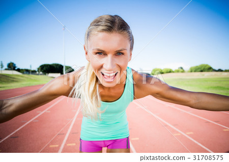 Portrait of excited female athlete posing after a victory 31708575