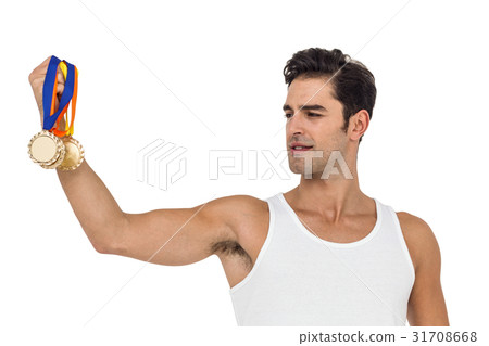 Athlete posing with gold medals 31708668