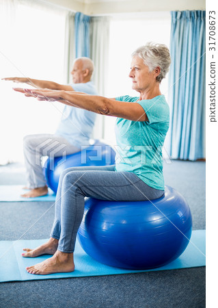 Seniors using exercise ball Seniors using exercise ball 31708673