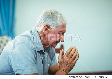 Worried senior man sitting in living room 31708675