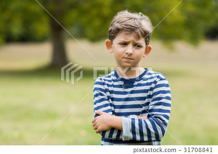 Portrait of upset boy standing with arms crossed Portrait of upset boy standing with arms crossed 31708841