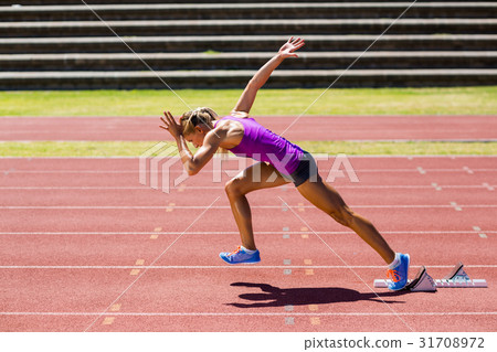 Female athlete running on the racing track 31708972