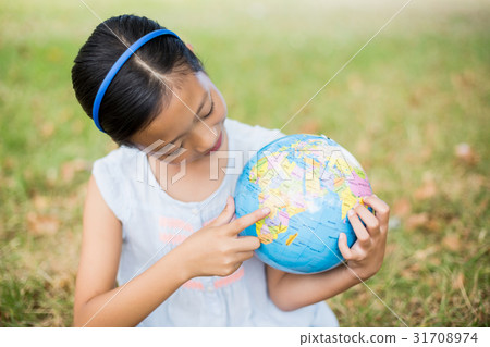 Smiling girl looking at globe Smiling girl looking at globe 31708974