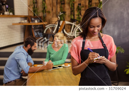 Waitress taking order on a notebook Waitress taking order on a notebook 31709024
