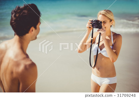 Woman taking picture of her man Woman taking picture of her man 31709248