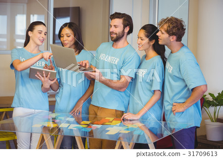 Volunteers using technology 31709613