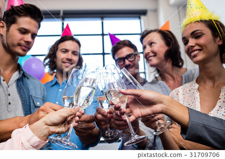 Happy coworker drinking champagne to celebrate a birthday Happy coworker drinking champagne to celebrate a birthday 31709706