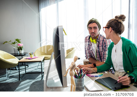 Casual colleagues using a graphic tablet Casual colleagues using a graphic tablet 31709708