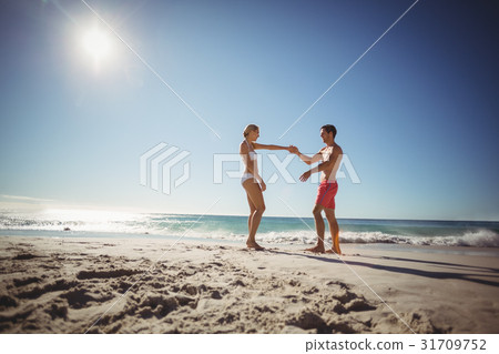 Couple dancing on beach 31709752