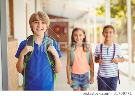 Smiling school kids standing in school corridor 31709771