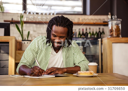 Man writing in a notebook Man writing in a notebook 31709850