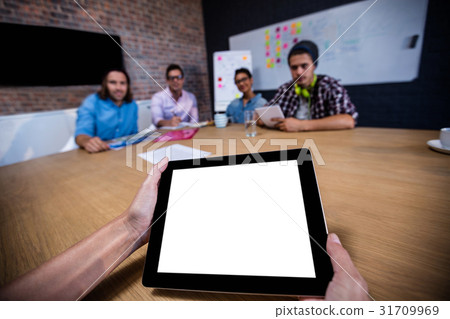 Photograph of a group of hipsters and a tablet computer Photograph of a group of hipsters and a tablet computer 31709969