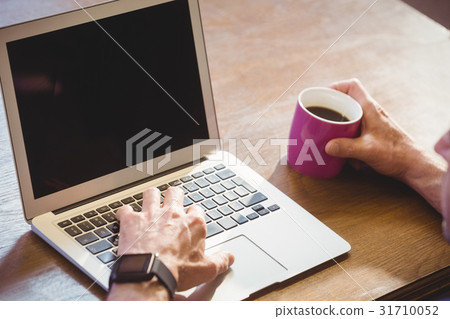 Businessman using his computer Businessman using his computer 31710052