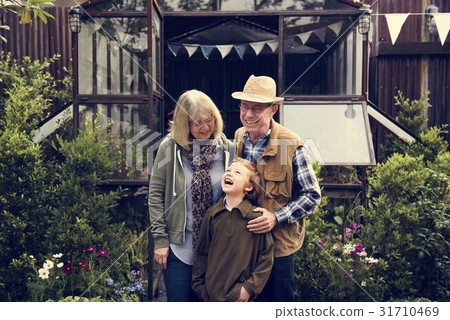 Senior Couple with Little Boy at Home Backyard Senior Couple with Little Boy at Home Backyard 31710469