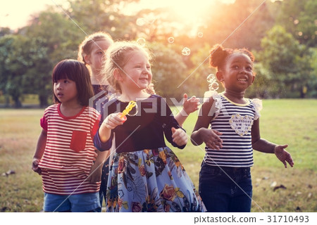 Group of kindergarten kids friends playing blowing bubbles fun 31710493