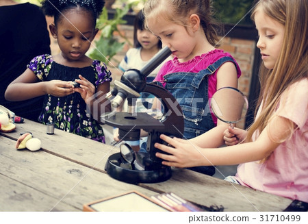 Group of children learning science by microscope 31710499