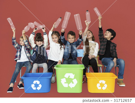 Kids and plastic bottles in a recycle bin 31712657