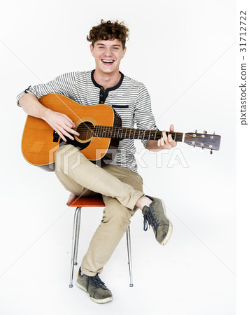 Man playing guitar relax and smiling Man playing guitar relax and smiling 31712722