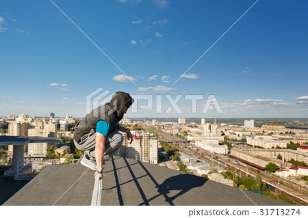 Roofer sits on the railing 31713274
