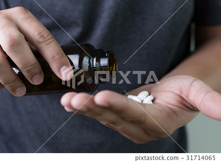 man hand holding frug medicine bottle on Herbal, man hand holding frug medicine bottle on Herbal, 31714065