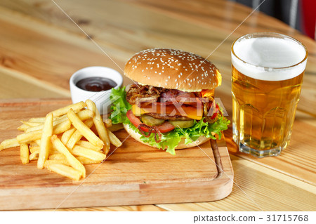 Big tasty burger and fries with beer on backround 31715768