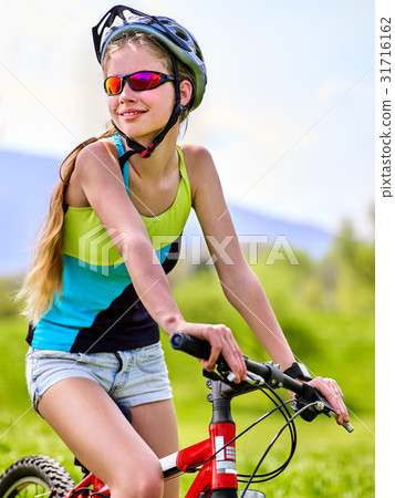 Woman traveling bicycle in summer park. Woman traveling bicycle in summer park. 31716162