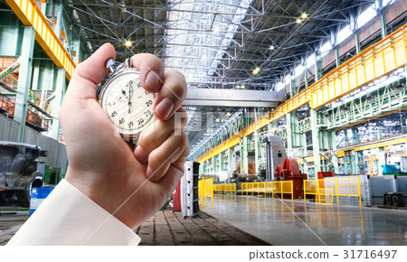 Machine shop and stopwatch in male hand 31716497