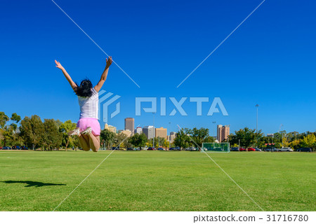 Happy woman jumping up in Adelaide city Happy woman jumping up in Adelaide city 31716780