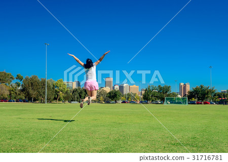 Happy woman jumping in Adelaide city Happy woman jumping in Adelaide city 31716781