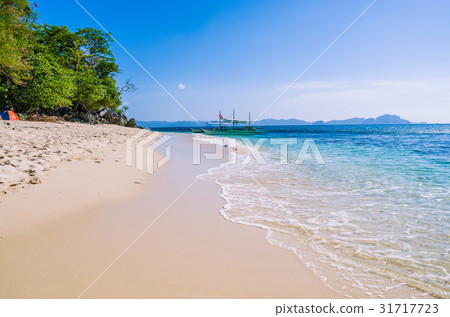 Traditional banca boat in clear water at sandy 31717723