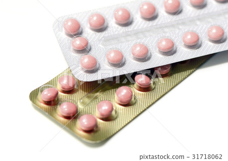 Pink pills in silver and gold strips 31718062