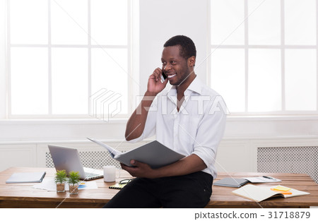 Young black businessman read documents and talk on Young black businessman read documents and talk on 31718879