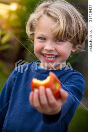 cute 5 year old child eating an apple cute 5 year old child eating an apple 31719425
